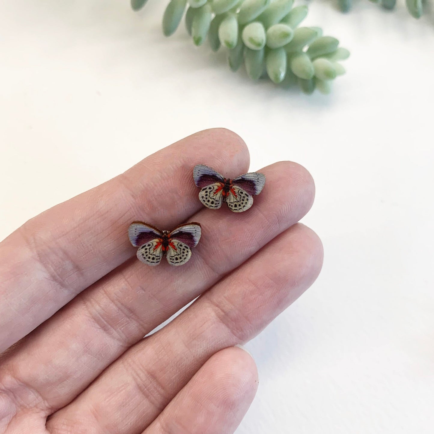 Tiny blue butterfly ear studs